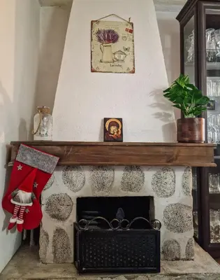 a fireplace with a christmas stocking on top of it at 8BD Retreat in Bansko Comfort & Mountain Charm by Flat Mаnager in Bansko