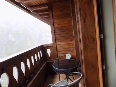 a balcony with a table and chairs on it at La'Vista in Smolyan