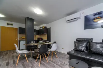 a living room with a table and chairs and a couch at PARADISE RELAX APARTMENT in Bansko