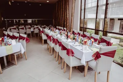 a long row of tables with red bows on them at PARADISE RELAX APARTMENT in Bansko