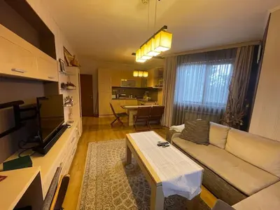 a living room with a couch and a table at Nikol 3 SPA CLUB BOR in Velingrad
