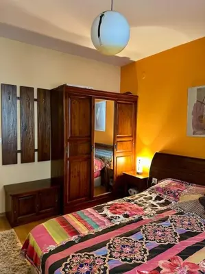 a bedroom with two beds and a mirror at Уникален апартамент с изглед към планината in Bansko