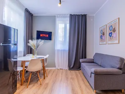 a living room with a couch and a table at Eiffel Elegance - Stylish Sofia Apartment in Sofia
