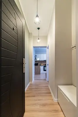 a hallway with a door leading to a kitchen at Eiffel Elegance - Stylish Sofia Apartment in Sofia