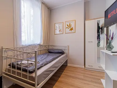a bedroom with a metal bed in a room at Louvre Loft: Charming Studio in Central Sofia in Sofia