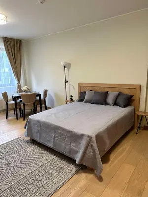 a bedroom with a large bed and a dining room at Lodge Euphoria Studio in Borovets