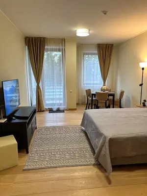 a bedroom with a bed and a table and chairs at Lodge Euphoria Studio in Borovets