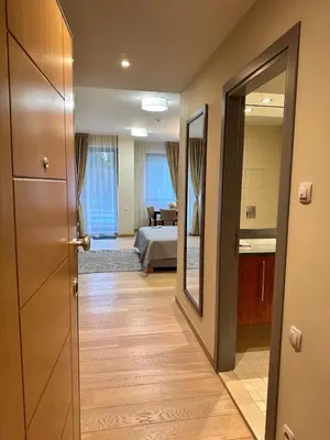 a hallway with a room with a bed and a mirror at Lodge Euphoria Studio in Borovets