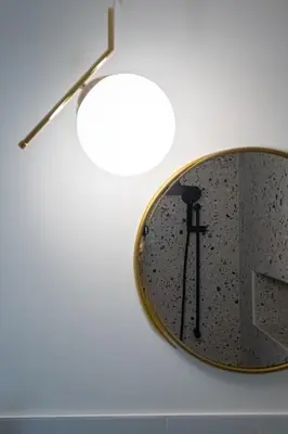 a mirror hanging on a wall in a bathroom at Eight Rooms Bansko in Bansko