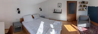 a bedroom with a bed and a chair in it at Eight Rooms Bansko in Bansko