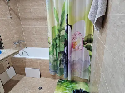 a bathroom with a tub and a shower curtain at TERRA KOMPLEX D3 - Private apartment - Golf, Skiing & SPA in Razlog