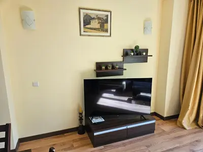 a living room with a fireplace and a table at TERRA KOMPLEX D3 - Private apartment - Golf, Skiing & SPA in Razlog