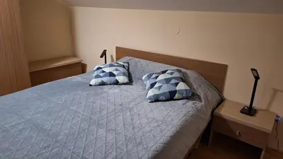 a bed with two blue and white pillows on it at Aspen Suites A403 - Sky & Stars Dreamers in Razlog