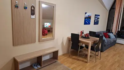 a living room with a table and a couch at Aspen Suites A403 - Sky & Stars Dreamers in Razlog