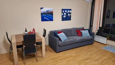 a living room with a couch and a table at Aspen Suites A403 - Sky & Stars Dreamers in Razlog