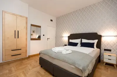 a bedroom with a bed with two towels on it at Luxury rooms 12-1 in Plovdiv