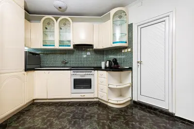 a kitchen with white cabinets and green tile at A Nostalgic Getaway in Plovdiv's Historic Quarter by Flat Mаnager in Plovdiv