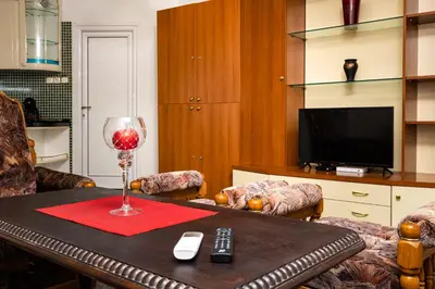a living room with a table with a wine glass at A Nostalgic Getaway in Plovdiv's Historic Quarter by Flat Mаnager in Plovdiv