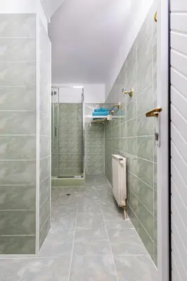 a bathroom with a shower and a tiled floor at A Nostalgic Getaway in Plovdiv's Historic Quarter by Flat Mаnager in Plovdiv