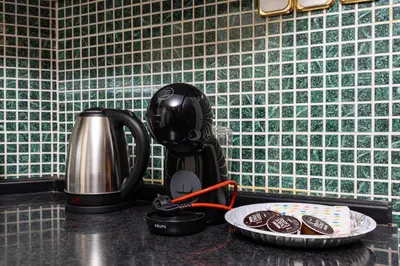 a kitchen counter with a coffee maker and a plate of cookies at A Nostalgic Getaway in Plovdiv's Historic Quarter by Flat Mаnager in Plovdiv