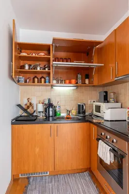 a kitchen with wooden cabinets and a microwave at One Bedroom Apartment Pirin Lodge in Bansko
