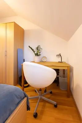 a bedroom with a desk and a white chair at One Bedroom Apartment Pirin Lodge in Bansko