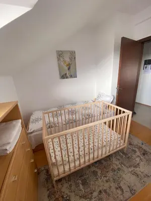 a small bedroom with a crib in a room at One Bedroom Apartment Pirin Lodge in Bansko