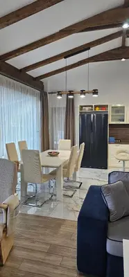 a living room with a white table and chairs at Relax Srednogorska Panorama in Smolsko