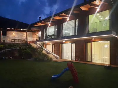 a house with a blue slide in front of it at Relax Srednogorska Panorama in Smolsko