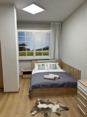 a bedroom with a large bed and a window at Apart-Hotel Crown Bansko in Bansko