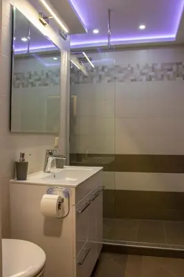 a bathroom with a sink and a mirror and a toilet at Newly renovated 2 bedroom apartment in Sofia in Sofia