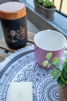 a table with a table cloth with a cup and a plate at Cozy Homes 1 in Sofia
