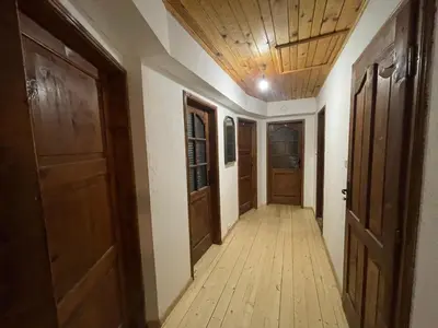 an empty hallway with wooden floors and doors at Villa Gusto, 3km from Pamporovo in Pamporovo