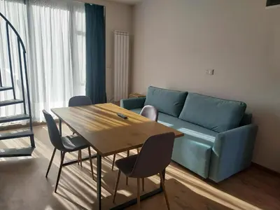 a living room with a blue couch and a table at Villa Doma in Sapareva Banya