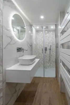 a white bathroom with a sink and a shower at Déja Blue Old City Center studio. in Sofia