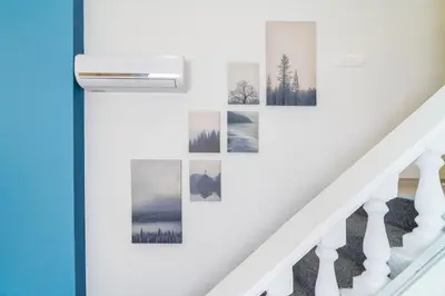 a wall of pictures on a stairwell with a stairwell at Déja Blue Old City Center studio. in Sofia
