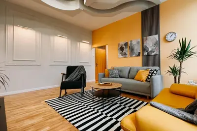 a living room with a couch and a table at Artiesta - 5 apartments in Sofia