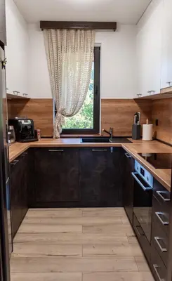 a kitchen with black cabinets and a window at Martini villa Lake in Razlog