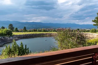 a view of a pond in a park with a bench at Martini villa Lake in Razlog