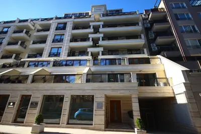 an apartment building with a car parked in front of it at SOFIA CENTRAL LUXURY apartment 