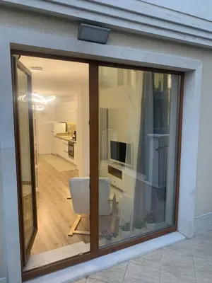 a glass window of a living room with a chair at SOFIA CENTRAL LUXURY apartment 