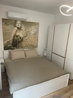 a bedroom with a bed with a painting on the wall at SOFIA CENTRAL LUXURY apartment 