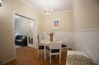 a dining room with a white table and chairs at Planeta dos sonhos - Fast Wi-Fi, 1BDR, Top centre in Sofia