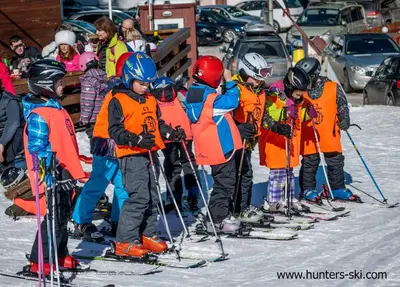a group of children on skis in the snow at Charming one bed apartment 423 in main Flora building in Borovets