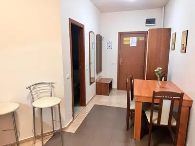 a dining room with a wooden table and chairs at Charming one bed apartment 423 in main Flora building in Borovets