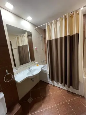 a bathroom with a sink and a shower curtain at Lorena’s Apartment Bansko,near Gondola in Bansko