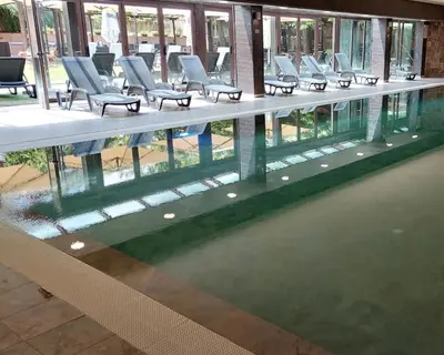 a row of chairs sitting next to a swimming pool at Lorena’s Apartment Bansko,near Gondola in Bansko