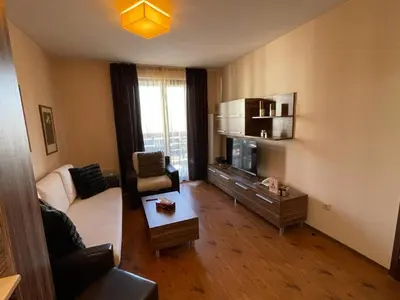 a living room with a couch and a table at Lorena’s Apartment Bansko,near Gondola in Bansko