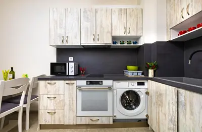 a kitchen with wooden cabinets and a dishwasher at Radiant Retreat - Bright 1BD Haven in Plovdiv by Flat Mаnager in Plovdiv