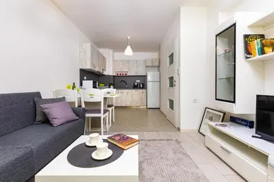 a living room with a couch and a table at Radiant Retreat - Bright 1BD Haven in Plovdiv by Flat Mаnager in Plovdiv